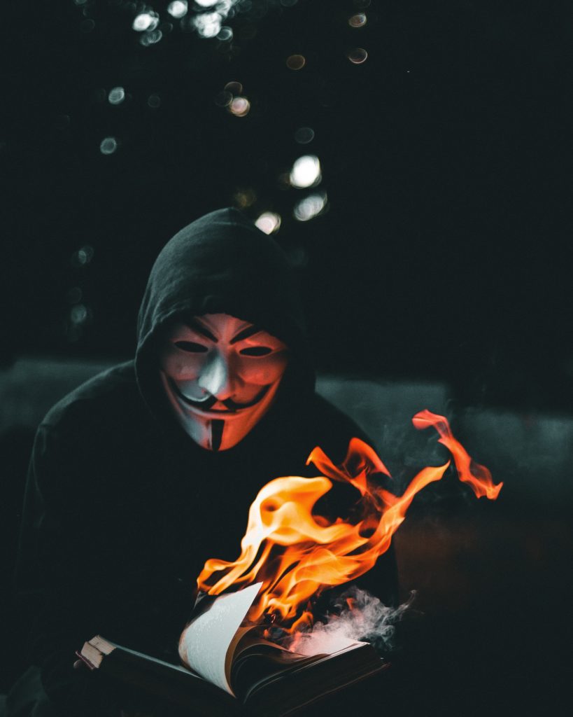 Man in guy Fawkes Mask Burning Paper - BYOBrand Purpose